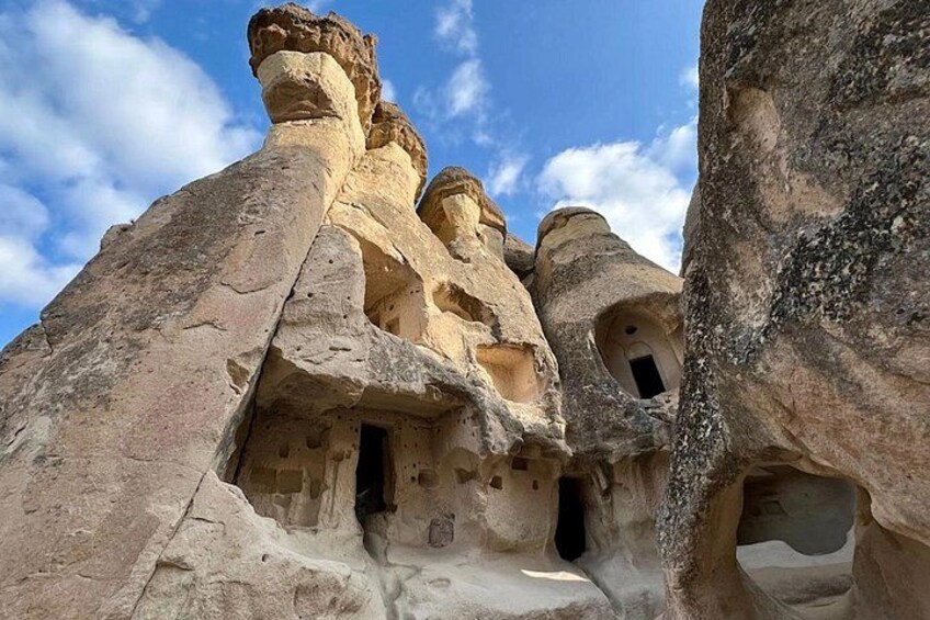 Rock formations with carved niches and a clear sky. 5