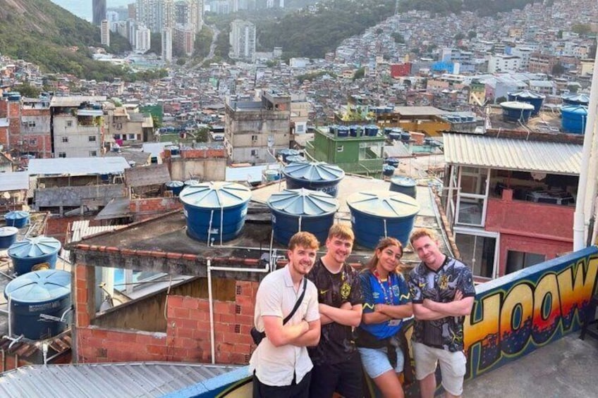 A group of people on a rooftop with a cityscape in the background. 3
