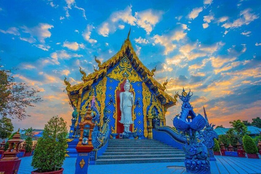 A temple with a large statue, intricate architecture, and a dragon sculpture. 2