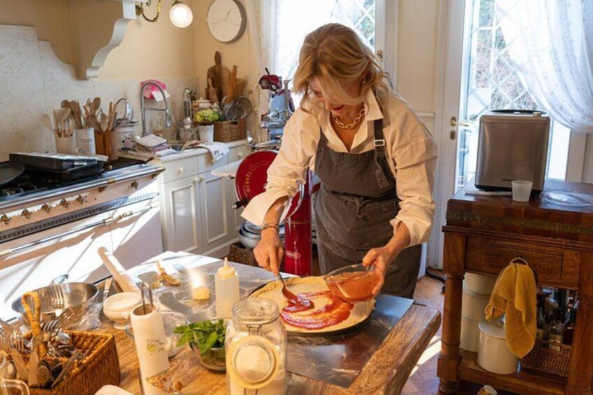 A person preparing food in a kitchen with a stove, utensils, and various kitchen items. 5