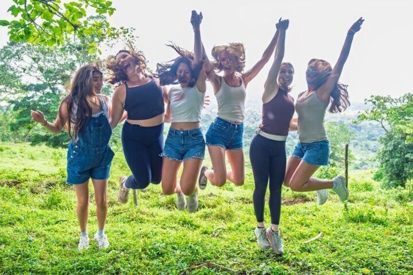 A group of people jumping in a grassy field. 2