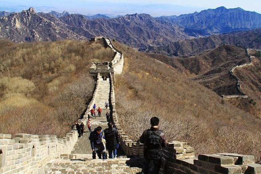 The Great Wall of China with hikers on a steep section. 3