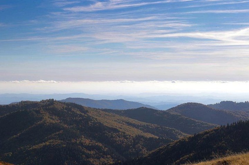 A mountainous landscape with rolling hills and a clear sky. 2