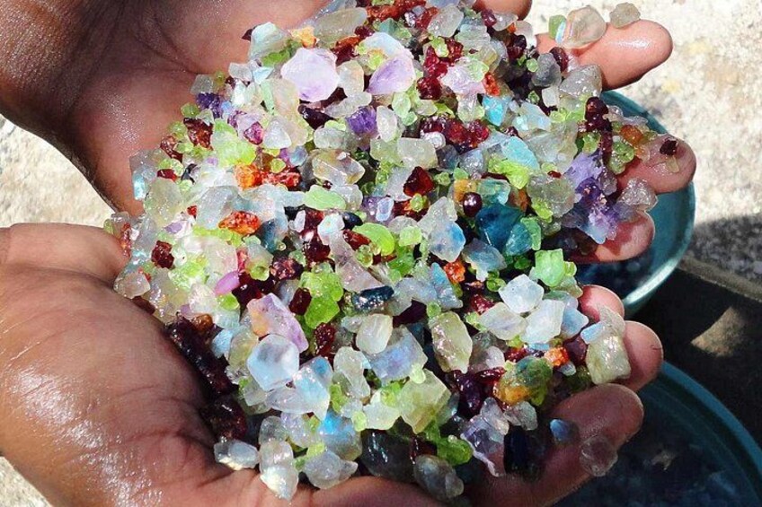 A person holding a collection of colorful crystals. 4