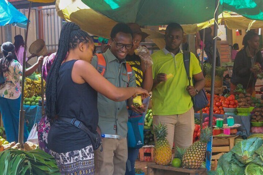 A market stall with fresh produce, including pineapples and tomatoes. 1