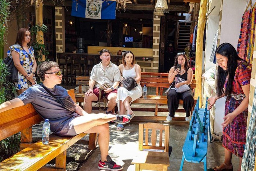 People sitting on benches in an outdoor cafe setting. 3