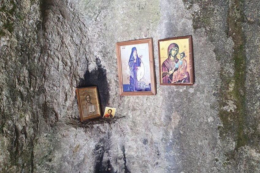 A wall with religious icons and a small shrine. 2