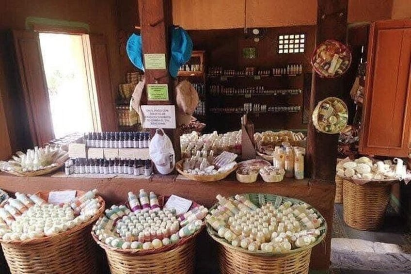 A market stall with baskets of various items, including bottles and jars, likely containing food products or condiments. 3