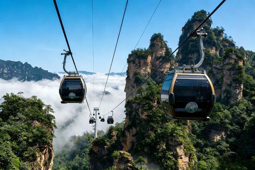 Cable cars suspended over a mountainous landscape with lush greenery and rocky cliffs. 4