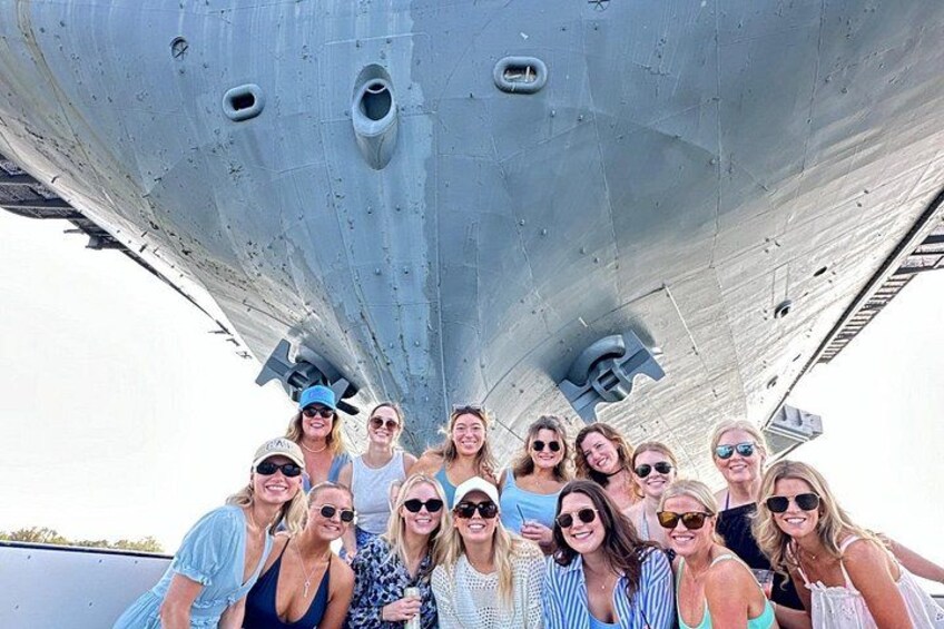 A group of people posing in front of a large aircraft. 3