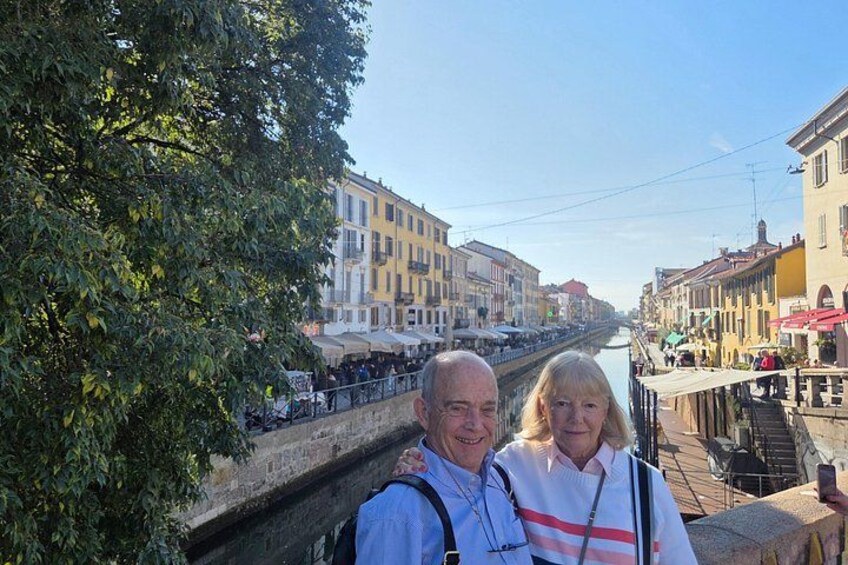 A couple taking a selfie with a canal and buildings in the background. 5