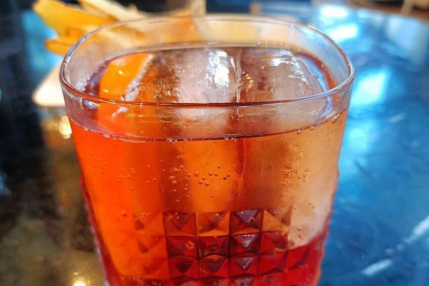 A glass of iced tea with ice cubes and a slice of orange. 3