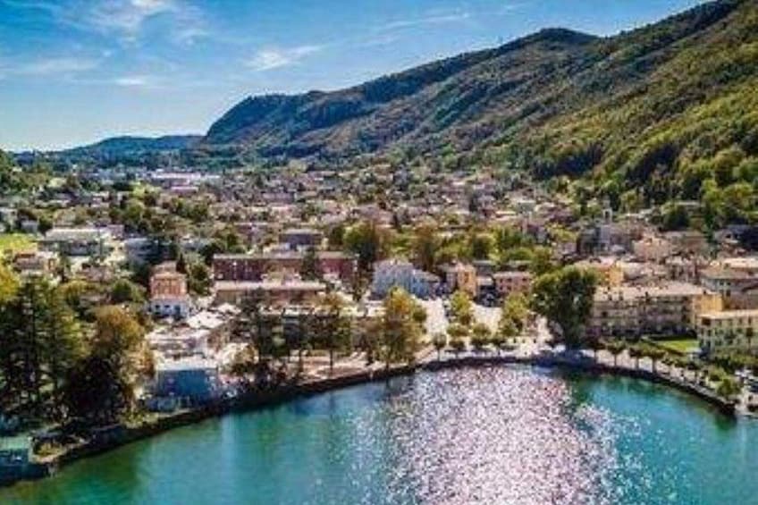 A town nestled by a river, surrounded by hills. 5