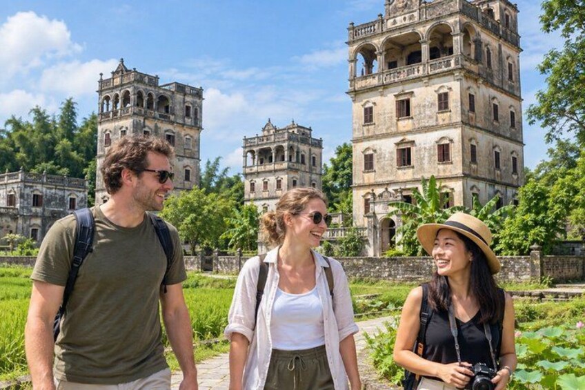 Three people walking in a historical site with ancient buildings. 1