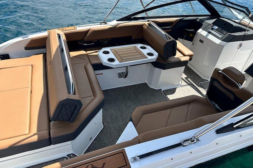 A boat's interior with seating, a control panel, and a storage area. 5