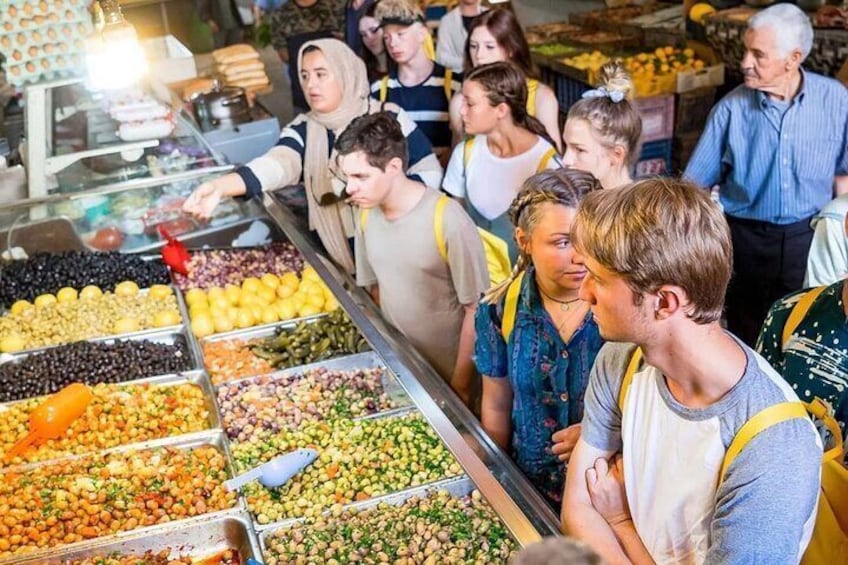 A food market with various vendors and customers. 4