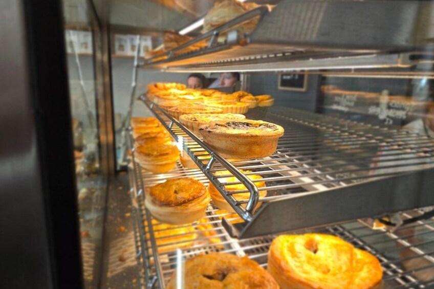 A bakery display case with muffins and pastries. 4