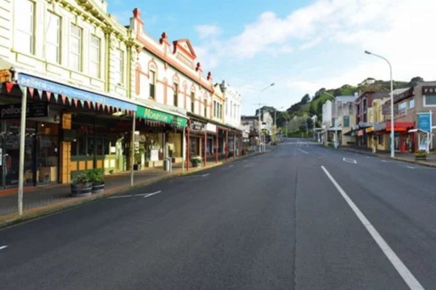 A quiet street lined with shops and buildings. 2