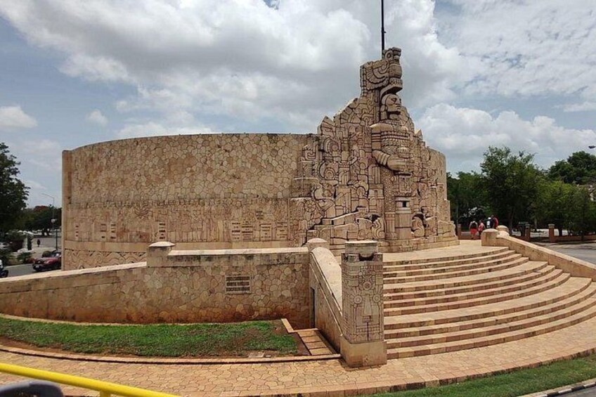A large stone structure with intricate carvings, a central staircase, and a flagpole. 3