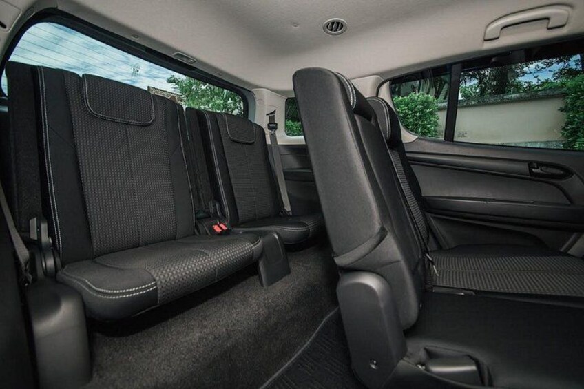 Ein Auto Innenraum mit schwarzen Sitzen, einer Mittelkonsole und einem Rückspiegel. 2