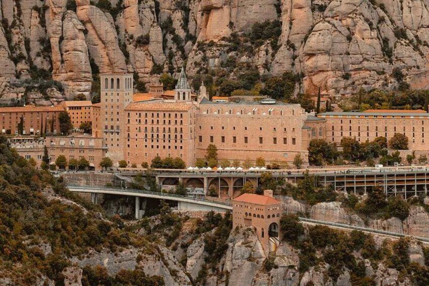 A large building complex with a bridge and rocky terrain. 3
