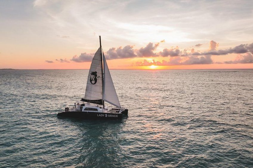 A sailboat named 'Lady Grace' on calm waters during sunset. 4