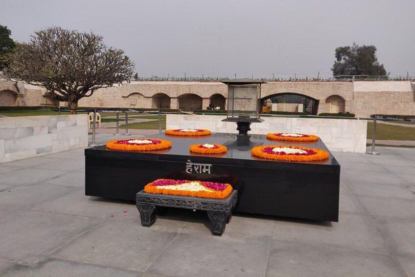 A memorial with flower arrangements and inscriptions. 2