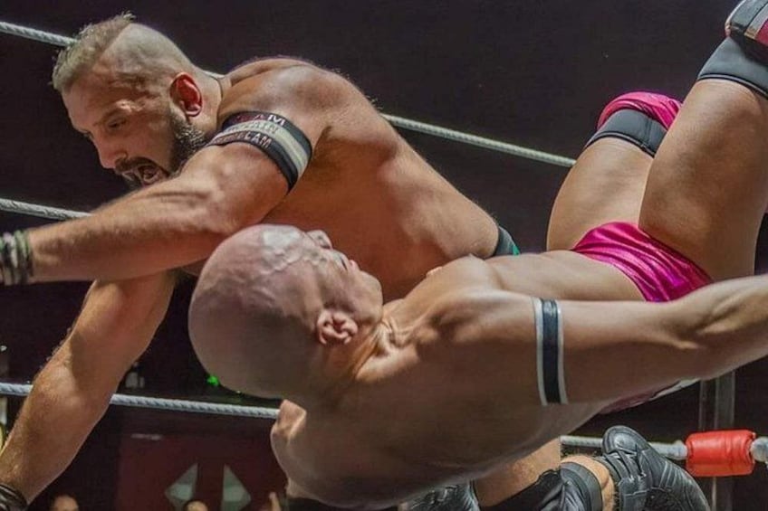 A wrestling match with two competitors in a ring. 1