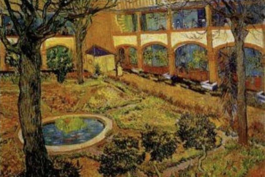 A garden with a fountain, trees, and a building with arched windows. 2