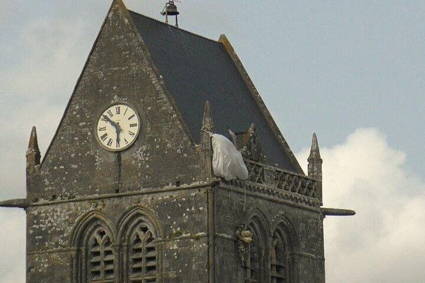 A mannequin representing John Marvin Steele, an American paratrooper who was hanging from the bell tower of Sainte-Mère-Eglise during the night of June 5-6, 1944 5