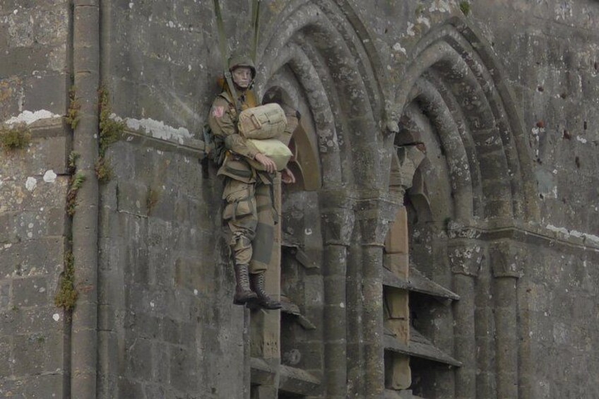 A mannequin representing John Marvin Steele, an American paratrooper who was hanging from the bell tower of Sainte-Mère-Eglise during the night of June 5-6, 1944 4