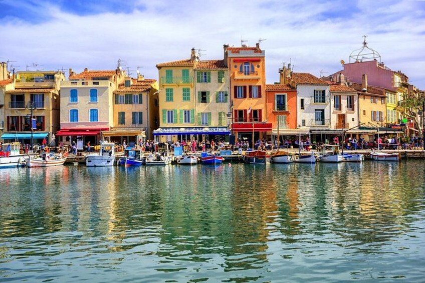 A waterfront with colorful buildings and boats docked along the shore. 5