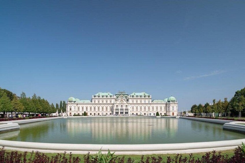 A large, ornate building with a reflecting pool in front. 3
