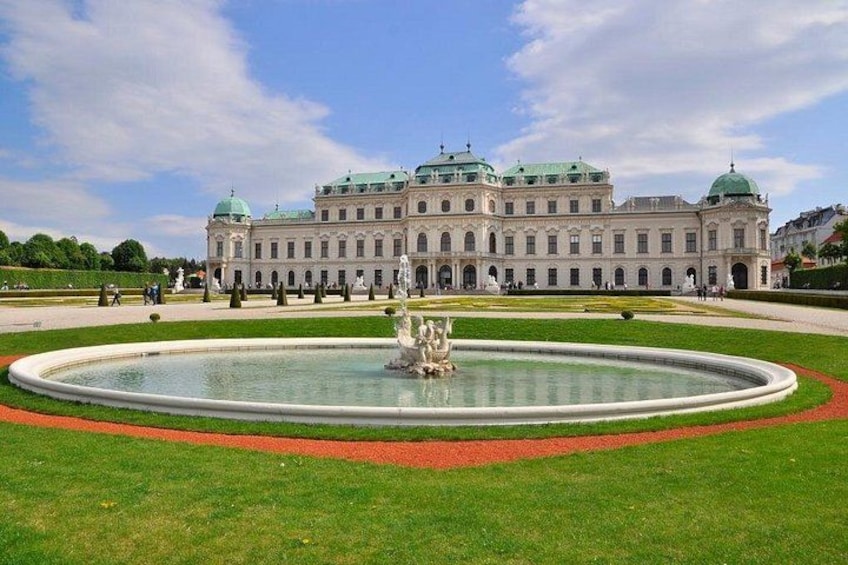 A large historic building with a fountain in the foreground. 5