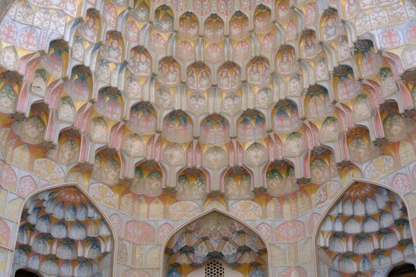 A detailed ceiling with intricate geometric patterns and arches. 3