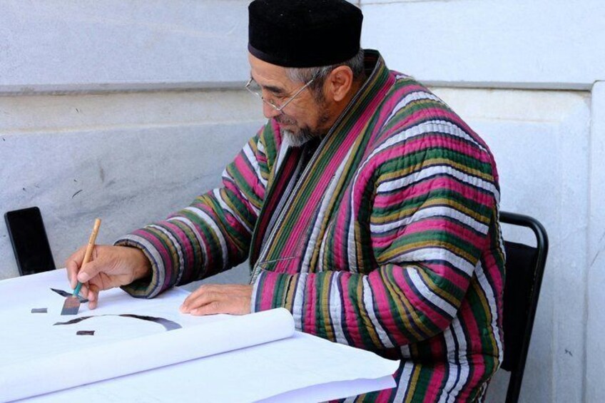 A person writing on paper at a table. 4