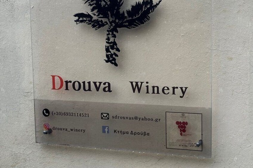 A sign for Drouva Winery with contact information and social media icons. 5