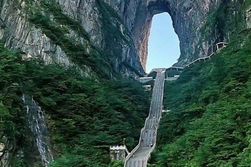 A road through a canyon with a natural arch formation. 3
