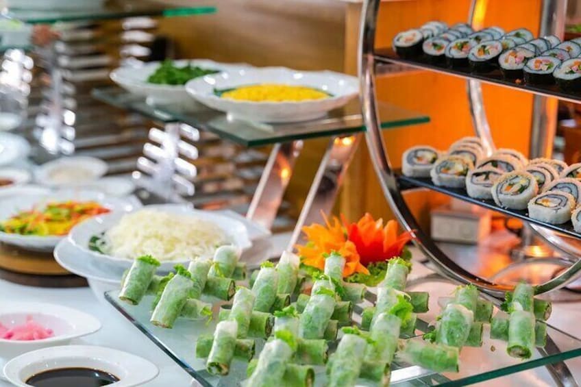 A buffet with various dishes including sushi rolls, rice, and vegetables. 3