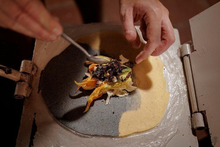 A person cooking with a pan on a stove. 4
