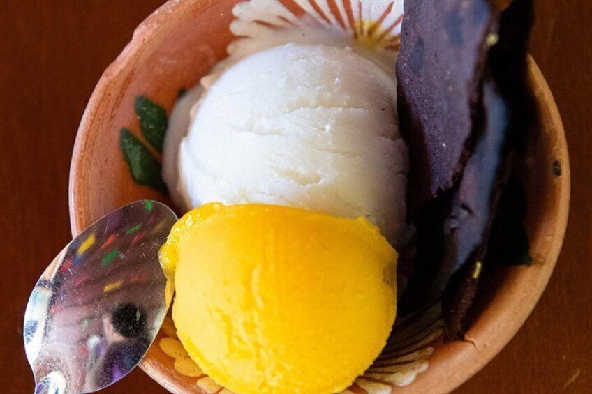 A bowl of ice cream with a spoon. 2
