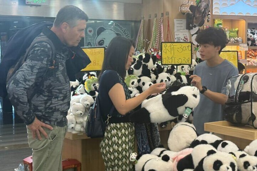 A store with a display of panda plush toys. 1