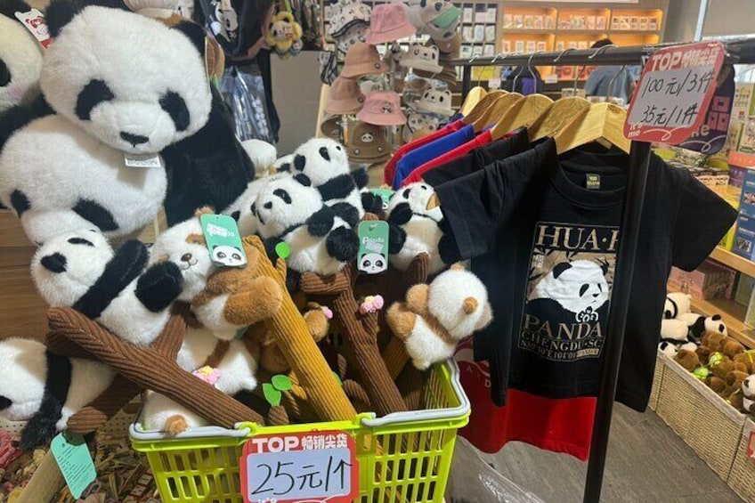 A display of panda plush toys and a T-shirt with panda print. 5