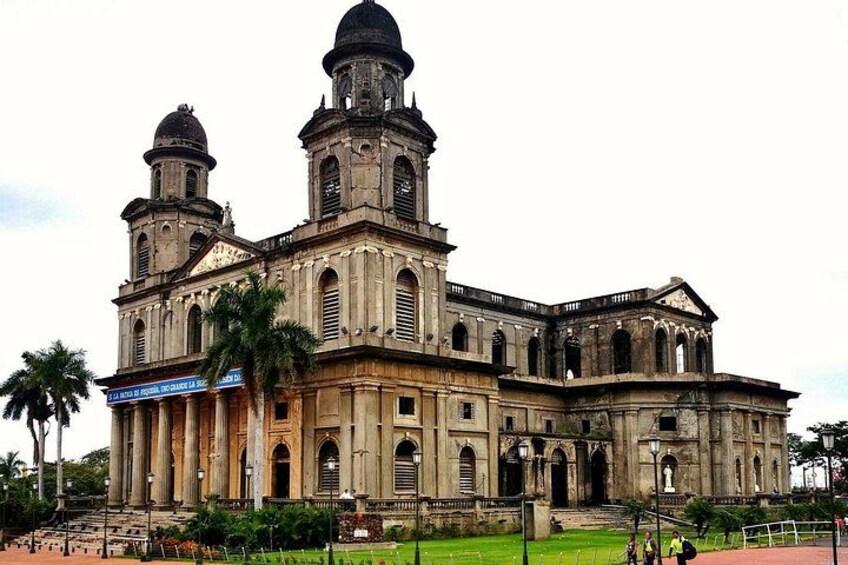 A large, historic building with two prominent towers and a central dome. 5