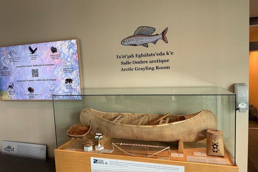 An Arctic Grayling Room with a display of a traditional boat and artifacts. 5