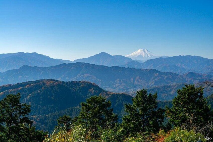 A mountain range with a prominent snow-capped peak in the distance. 1