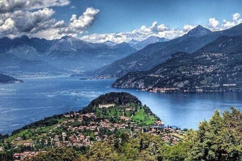 A mountainous landscape with a lake, a village, and a prominent hill. 3