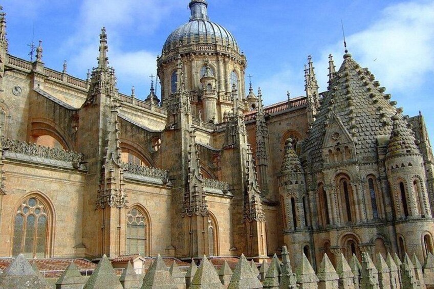 A historic cathedral with intricate architecture, a prominent dome, and a series of pointed towers. 3