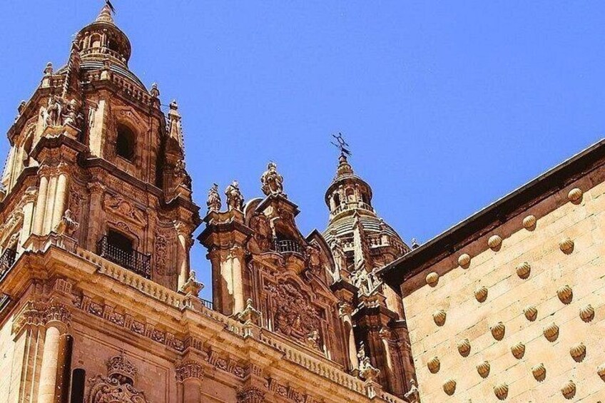 A historic building with ornate architecture, including multiple domes and statues. 2