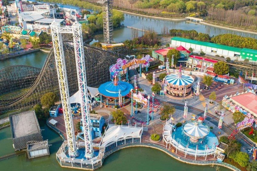 A roller coaster, a Ferris wheel, and a carousel at an amusement park. 4